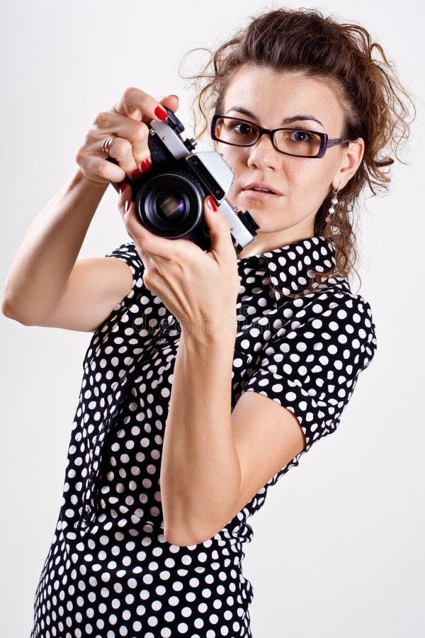 Beautiful woman in a polka dot dress with camera