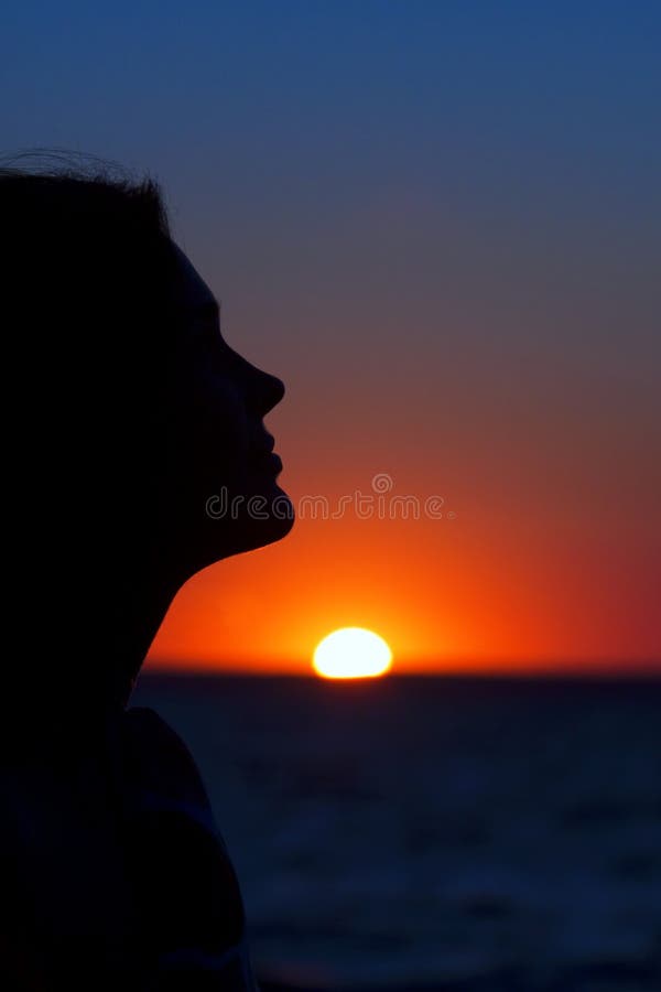 A beautiful woman profile against the sunset