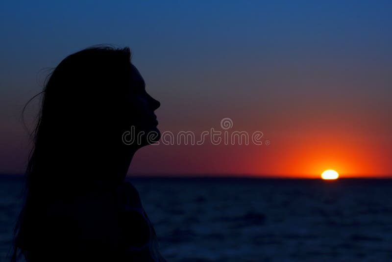 A beautiful woman profile against the sunset