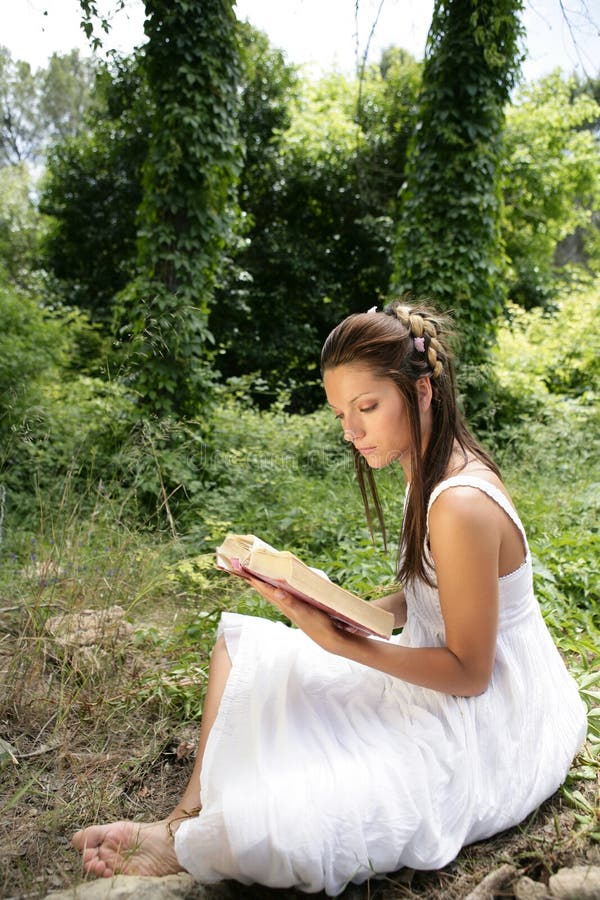 Beautiful woman reading happy a book in forest, green nature outdoor. Beautiful woman reading happy a book in forest, green nature outdoor