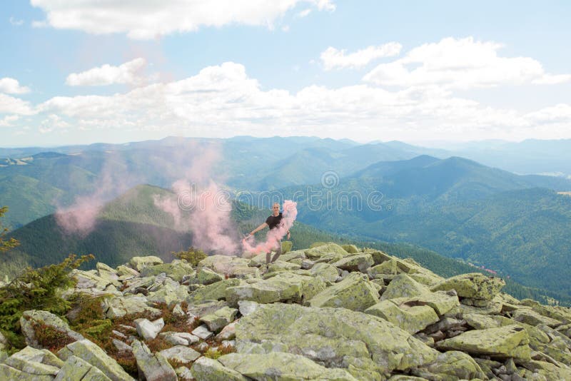 Beautiful Woman with Red Colored Smoke at the Top of the Mountain and ...