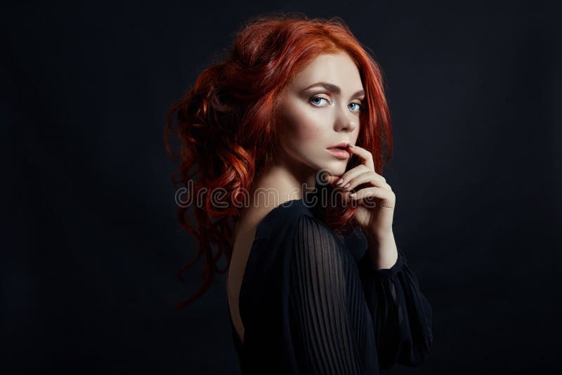 Beautiful woman with red hair on a black background. Portrait of a successful woman, pure skin, natural makeup, skin care face stock photos Beautiful woman with red hair on a black background. Portrait of a successful woman, pure skin, natural makeup, skin care face stock photos