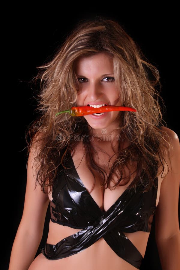 Beautiful woman with red pepper on black