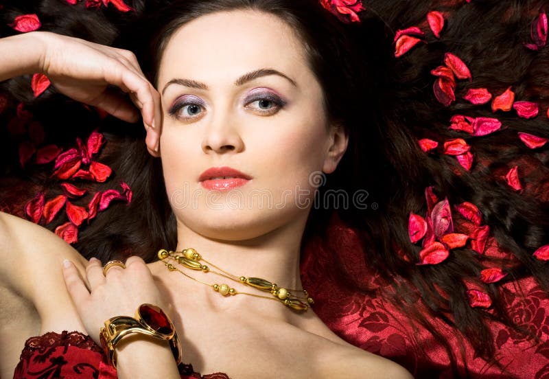 Beautiful woman in red petals