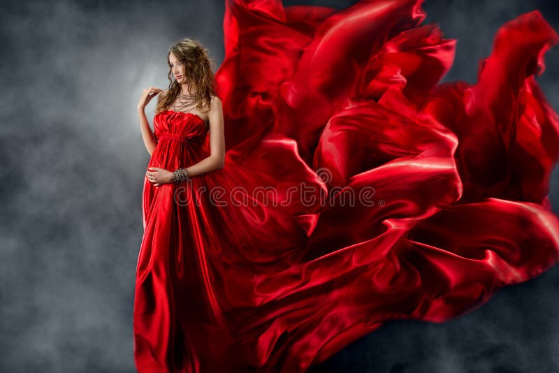 Beautiful woman in red waving silk as flame stock photos Beautiful woman in red waving silk as flame stock photos