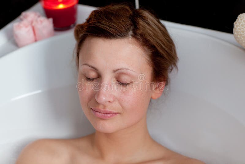 Beautiful woman relaxing in a bath royalty free stock image