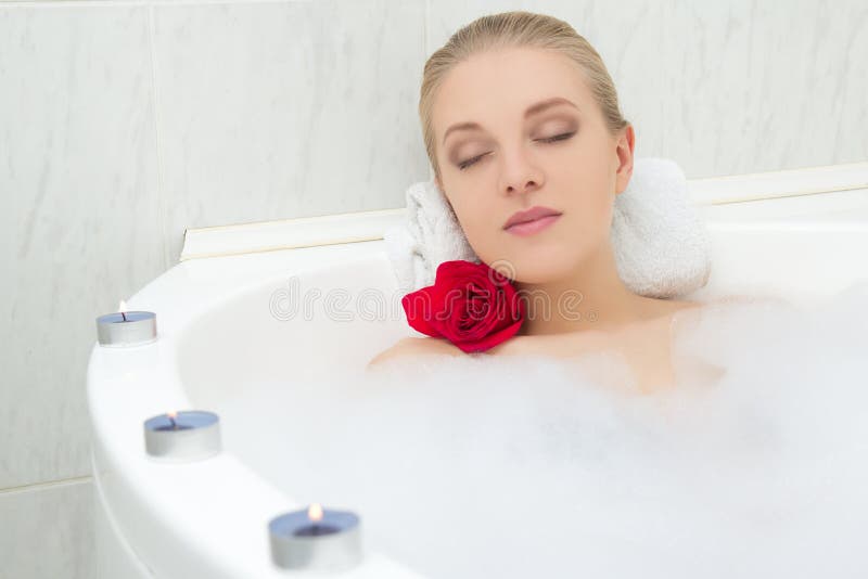 Woman taking relaxing bath Stock Photo by ©belchonock 138135236