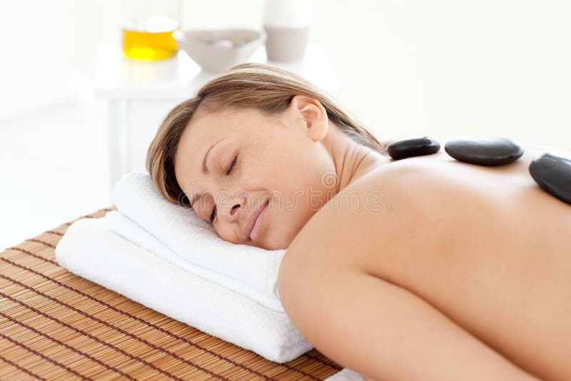 Beautiful woman relaxing on a massage table stock photo