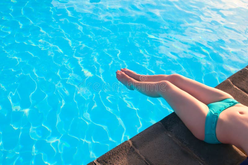 Beautiful woman relaxing in a swimming pool royalty free stock image