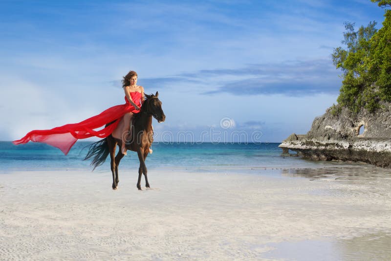 Beautiful woman riding a horse on tropical beach