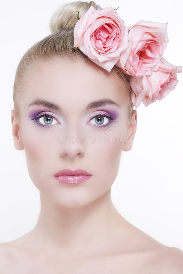 Beautiful woman with roses in hair