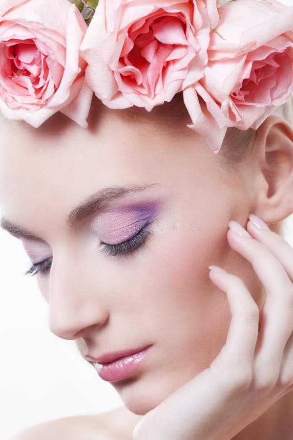 Beautiful woman with roses in hair