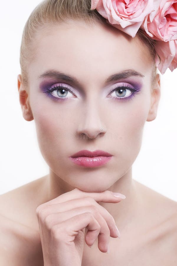 Beautiful woman with roses in hair