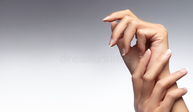 Beautiful woman`s hands on light background. Care about hand. Tender palm. Natural manicure, clean skin. French nails