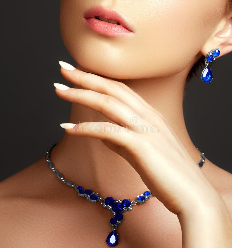 Beautiful woman with a sapphire necklace. Fashion concept