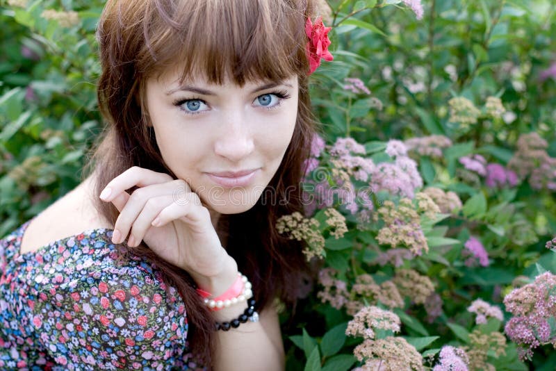 Beautiful woman sitting on meadow