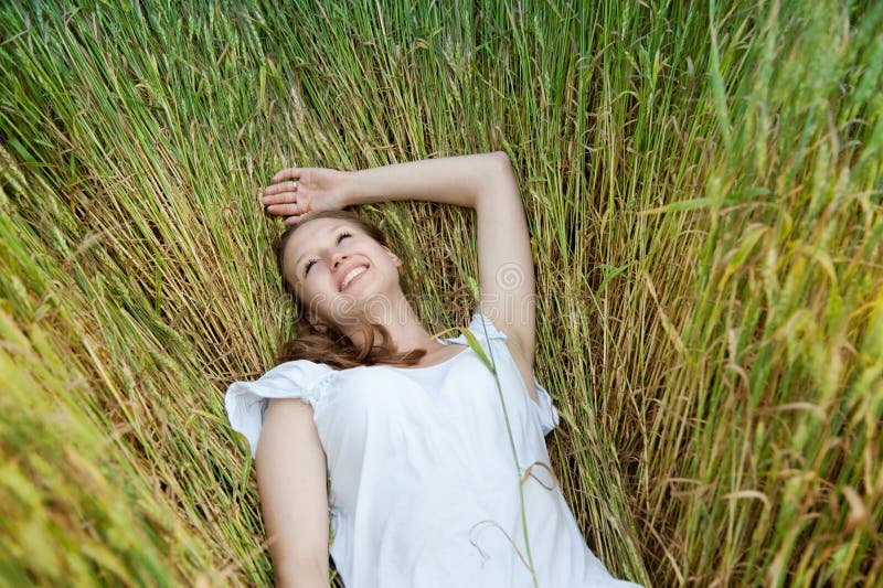 Beautiful woman smiles in field