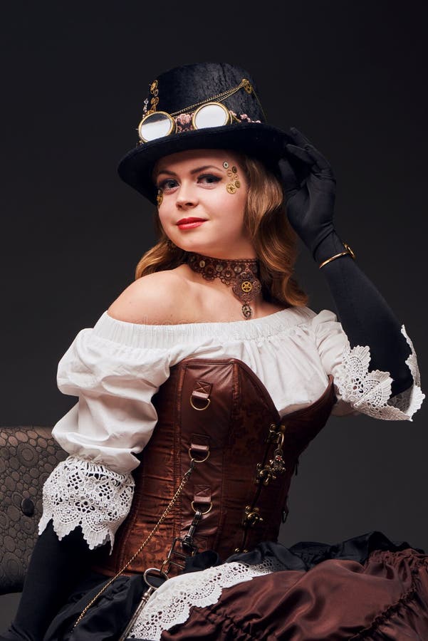 Beautiful woman in steampunk style sitting on the chair stock photo Beautiful woman in steampunk style sitting on the chair stock photo