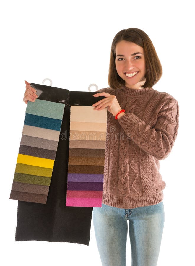 Beautiful woman in sweater holding fabric swatches