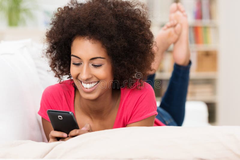 Beautiful woman texting on her mobile stock image Beautiful woman texting on her mobile stock image