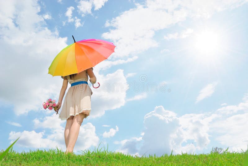 Beautiful woman with umbrella and cloud sky