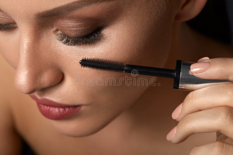 Beautiful Woman Using Black Mascara On Closed Eyes