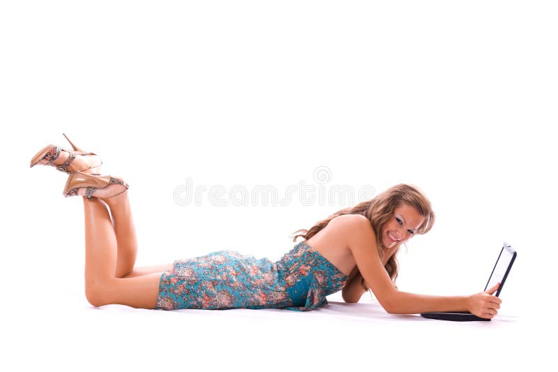 Beautiful woman using laptop, lying on the floor.