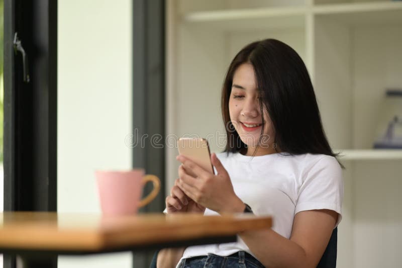 A beautiful woman is using a mobile phone. stock images