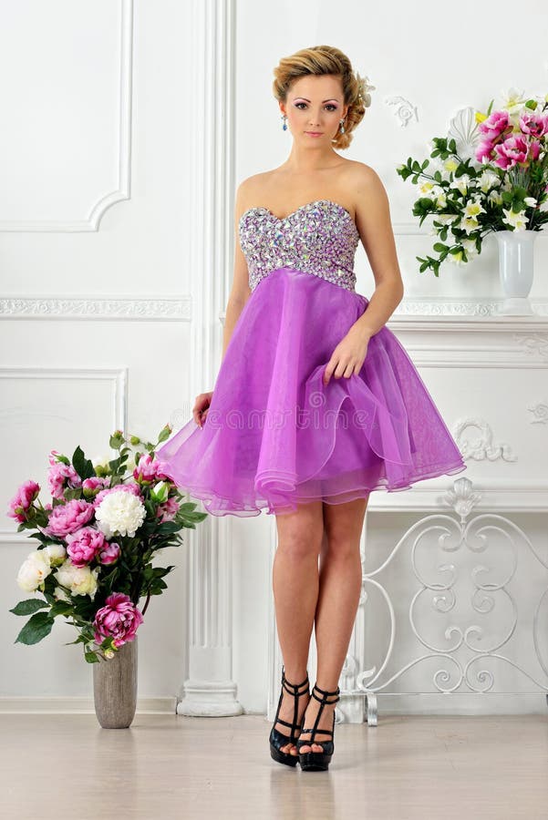 Beautiful Woman in Violet Dress in Luxury Studio. Stock Photo - Image ...