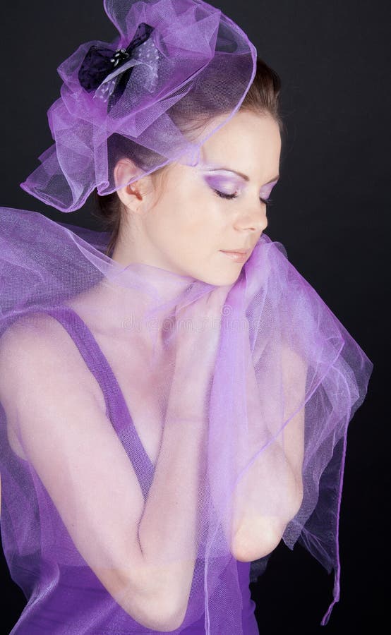 Beautiful woman in violet hat with closed eyes