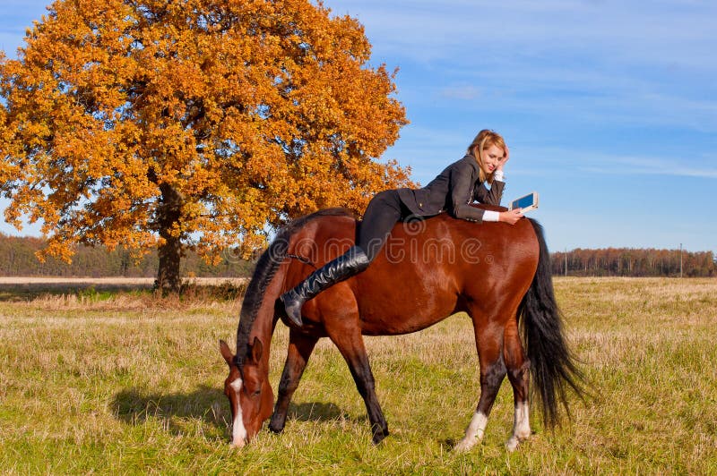 Beautiful woman walking with horse