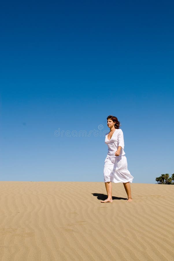 Beautiful woman walking in the sand