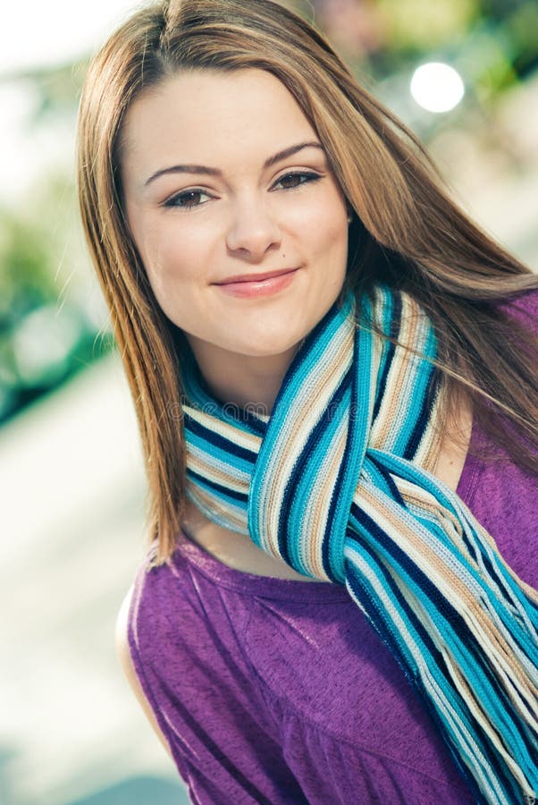 Beautiful woman wearing a blue scarf outdoors