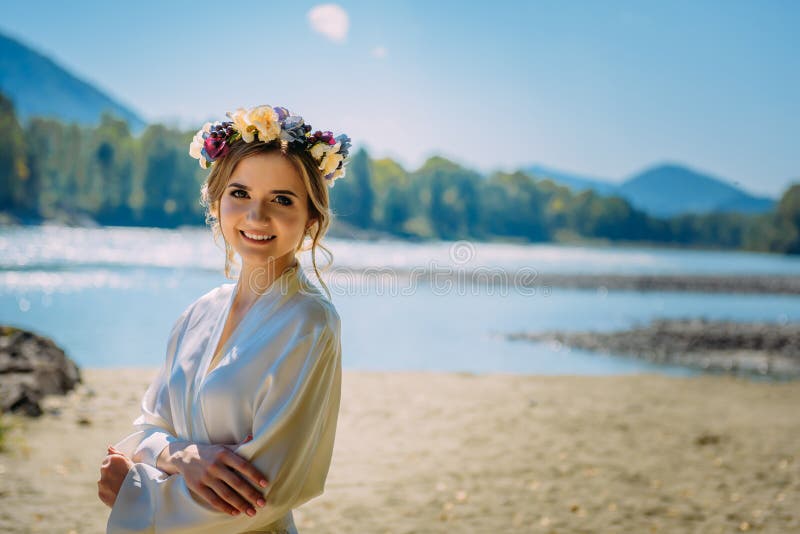 Beautiful woman wearing white dress and circlet of flowers in wild nature royalty free stock photo Beautiful woman wearing white dress and circlet of flowers in wild nature royalty free stock photo