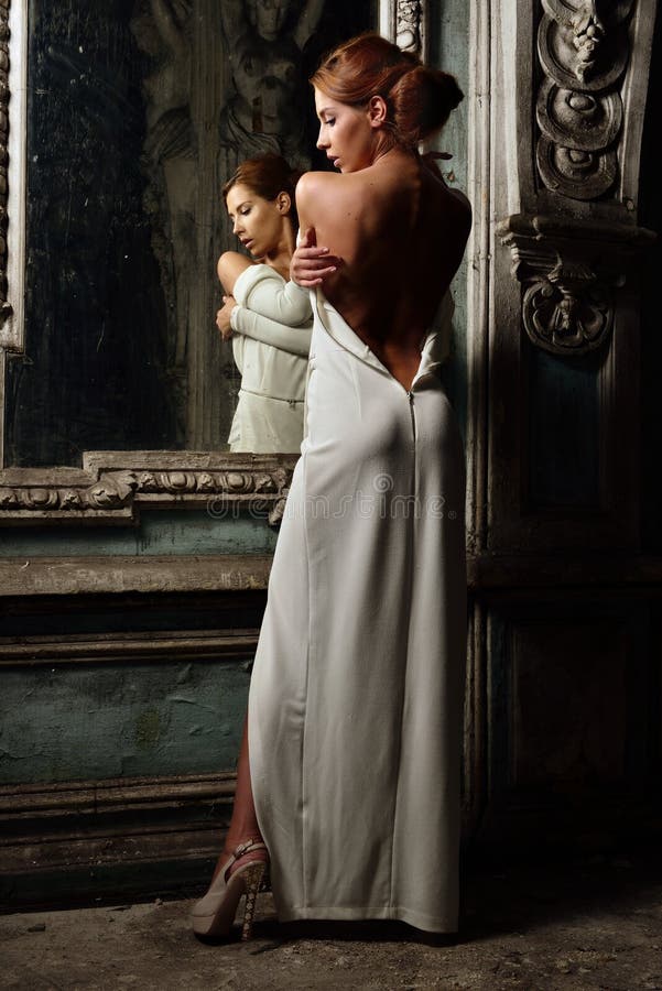 Beautiful woman in white dress with naked back. royalty free stock image Beautiful woman in white dress with naked back. royalty free stock image