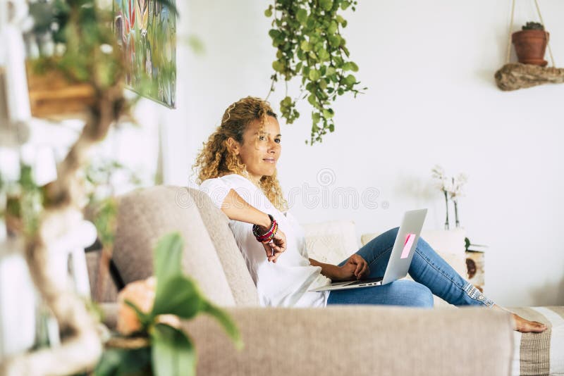 Beautiful woman work and have relax at home with laptop computer - concept of smart work and alternative office - female enjoy