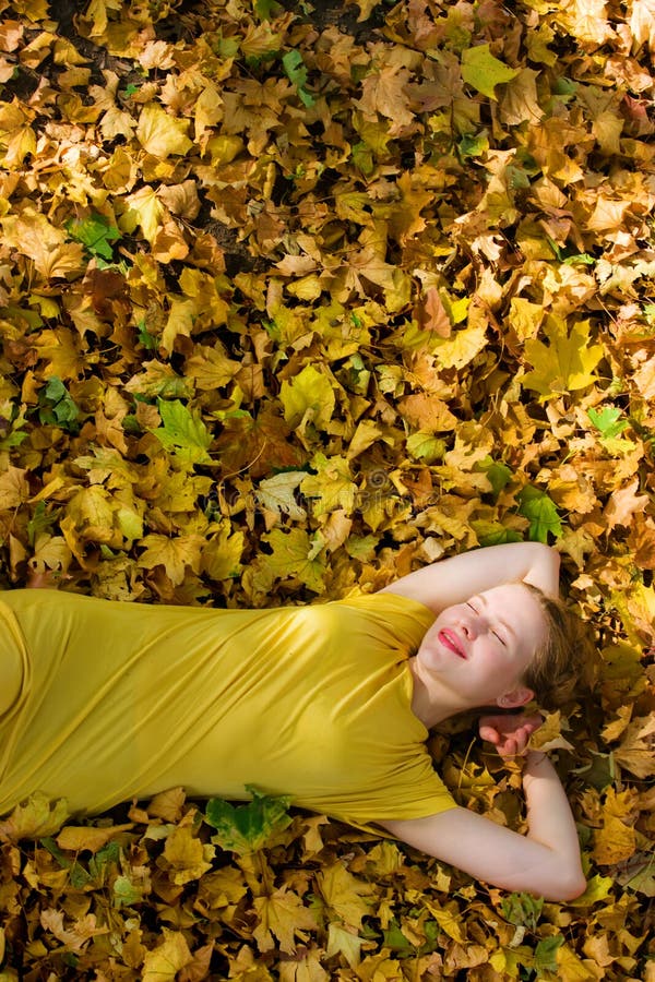 Beautiful woman - yellow autumn leaves - fall