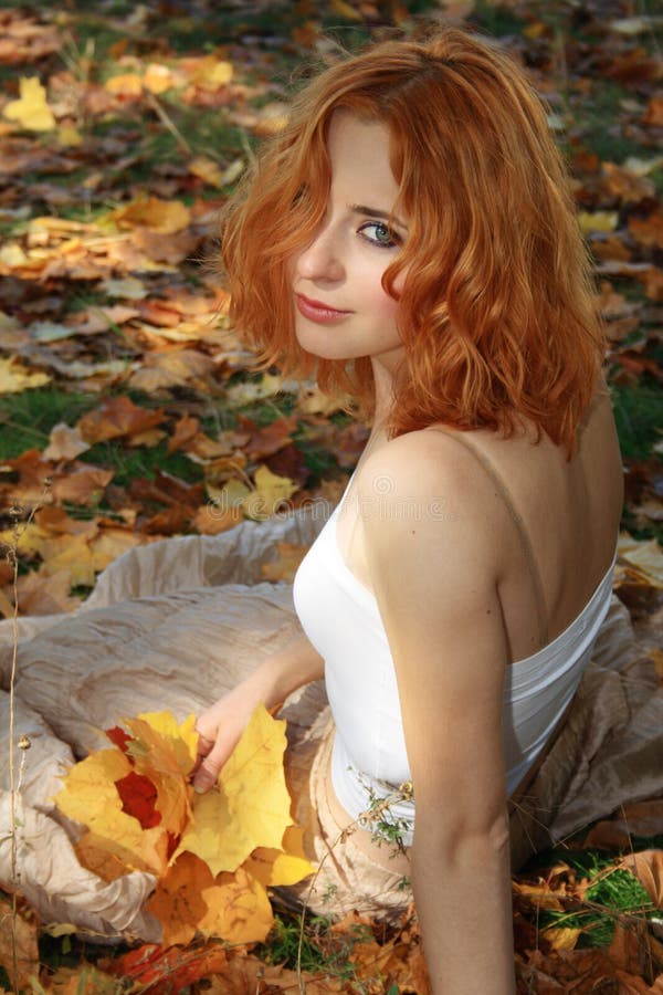 Beautiful woman in yellow leaves