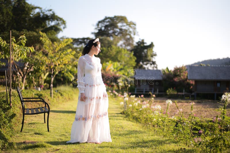 Beautiful women In the field of flowers and sunshine. Beautiful woman In the field of flowers and sunshine in the morning stock images Beautiful women In the field of flowers and sunshine. Beautiful woman In the field of flowers and sunshine in the morning stock images