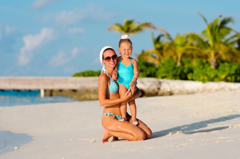 Beautiful women and her daughter on the beach