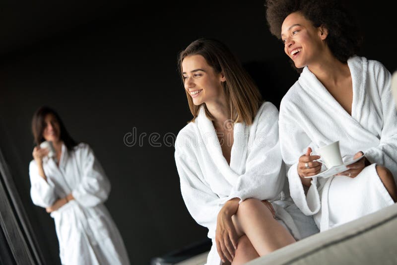 Women Relaxing and Drinking Tea in Robes during Wellness Weekend Stock ...
