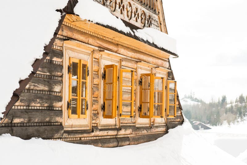 Beautiful wooden cottage covered in snow, ski resort Donovaly