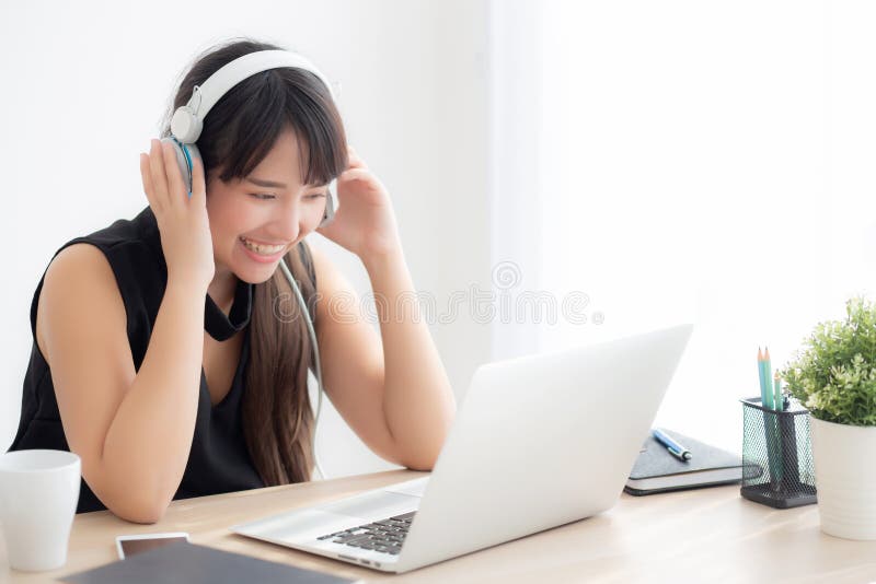 Beautiful young asian woman wear headphone smiling say hello using chat video call on laptop computer royalty free stock photos Beautiful young asian woman wear headphone smiling say hello using chat video call on laptop computer royalty free stock photos