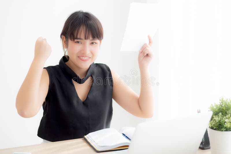 Beautiful young asian woman working laptop computer at office, businesswoman looking graph diagram analysis statistic