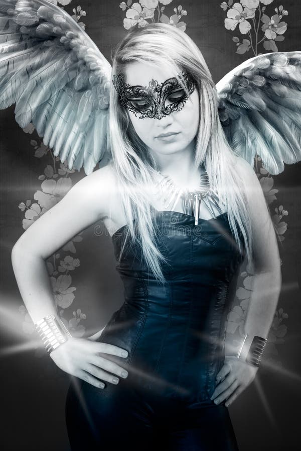 Beautiful young blond woman with mask, sensual and winged r stock photo