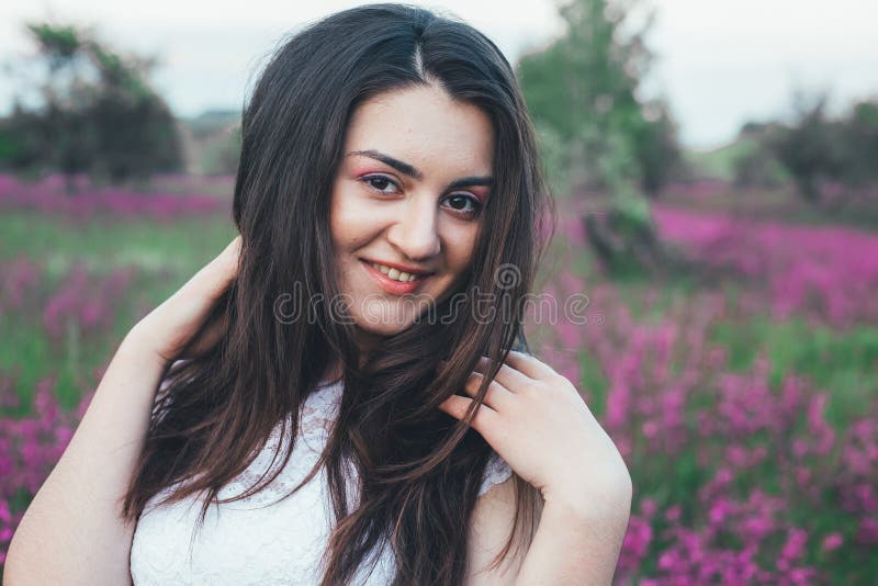 Beautiful young bride in field, happy woman enjoying flowers. royalty free stock photo Beautiful young bride in field, happy woman enjoying flowers. royalty free stock photo