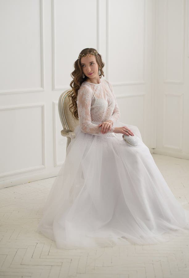 Beautiful young bride sitting on a chair royalty free stock photography Beautiful young bride sitting on a chair royalty free stock photography