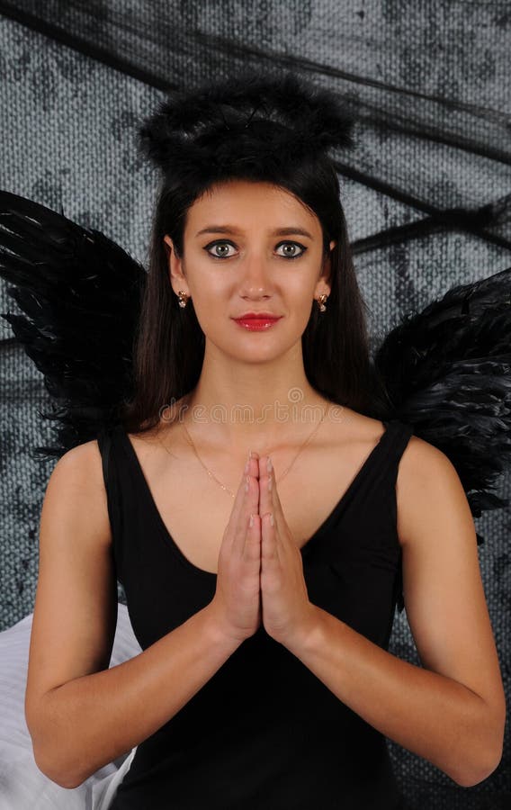 beautiful-young-brunette-woman-black-angel-costume-wings-over-dark-spooky-background-praying-pose-halloween-beautiful-196113094.jpg
