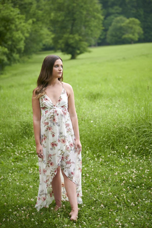 Beautiful Young Woman Walking in Sundress in Field of Grass Stock Image ...
