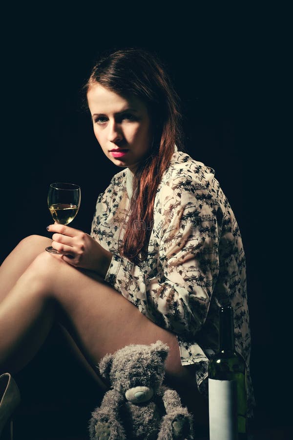 Beautiful Young Brunette Woman Holding A Bottle Of White Wine Stock